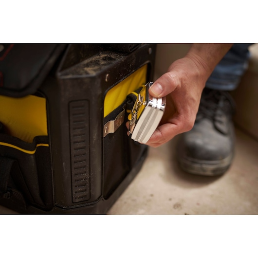 STANLEY 1-79-213 padlock attached to a yellow and black tool bag, close-up photography.