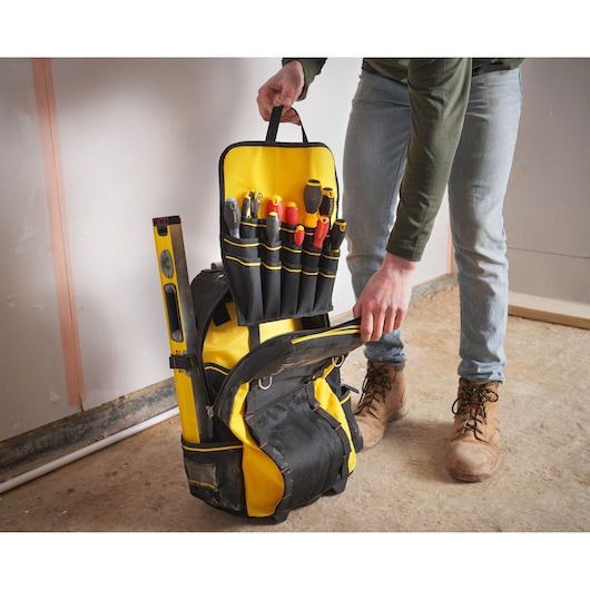 STANLEY 1-79-215 tool backpack with yellow and black design, open to show organized tools and level.