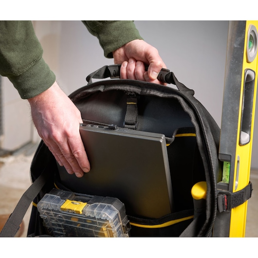 STANLEY 1-95-611 photography of a black tool backpack with laptop and organizer inside, front angle.