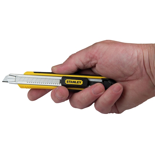 STANLEY 10-475 utility knife with yellow and black handle held in a hand, side angle.