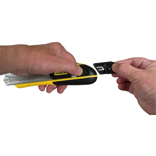 Photo of STANLEY 10-481 utility knife with hands showing blade changing feature, side angle, yellow and black handle.