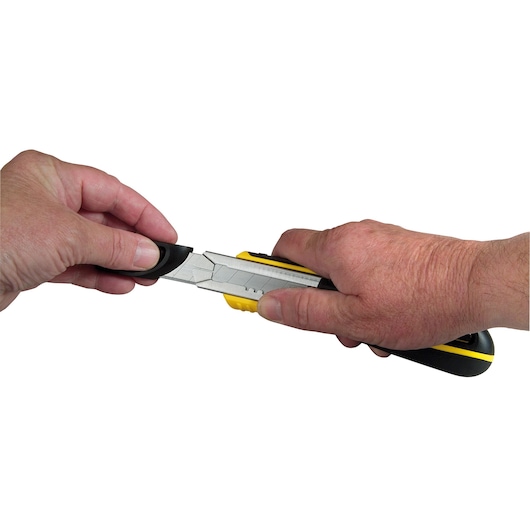 STANLEY 10-481 utility knife held in hands, silver blade extended, yellow and black handle, side view.