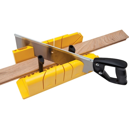STANLEY 20-600 hand saw and yellow miter box cutting wood strip, angled view, woodworking tool.