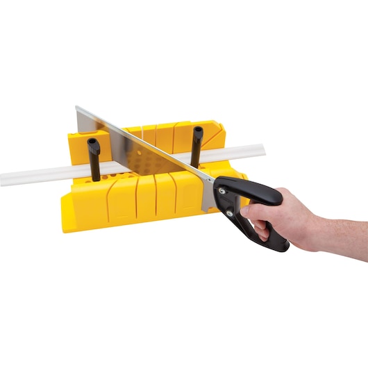 STANLEY 20-600 hand saw cutting white molding in yellow miter box, side angle, on white background.