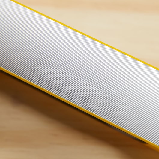 Photo of STANLEY 43-548 ruler with yellow edge and fine gray markings, diagonal close-up view.