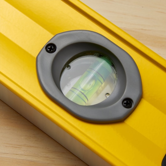 STANLEY 43-548 yellow level tool close-up showing bubble vial, photography, top angle.