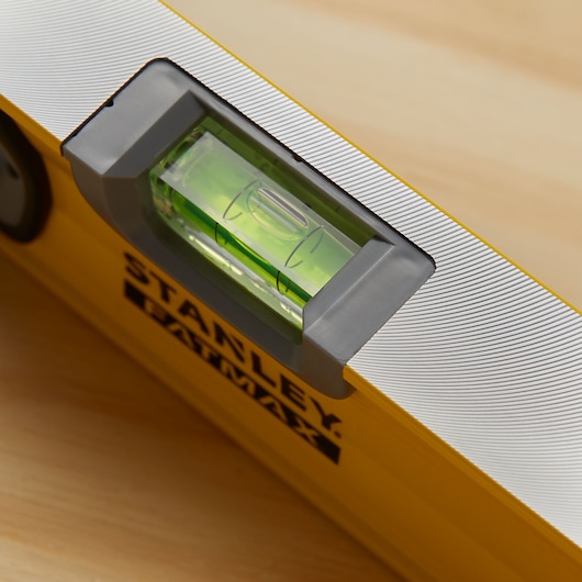STANLEY 43-548 yellow spirit level tool close-up with green vial and silver accents.