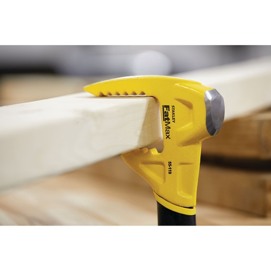 Photo of STANLEY FatMax 55-119 claw bar gripping wooden plank, close-up view.