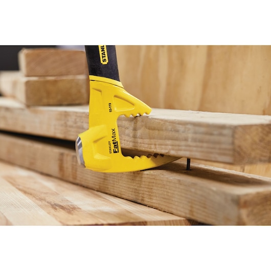 STANLEY 55-119 FatMax demolition tool prying wood boards with claw in construction setting.