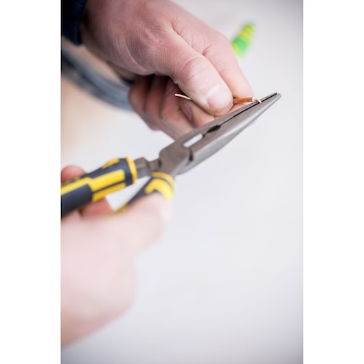 Photo of STANLEY 89-870 long nose pliers with yellow and black handle in use gripping a wire.