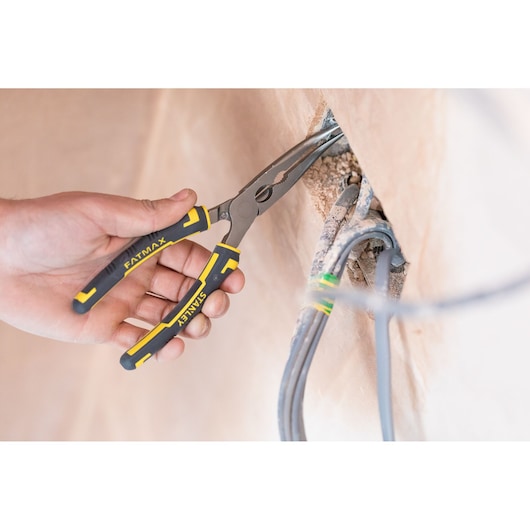 STANLEY 89-872 long nose pliers with black and yellow handles in use, gripping electrical wires.