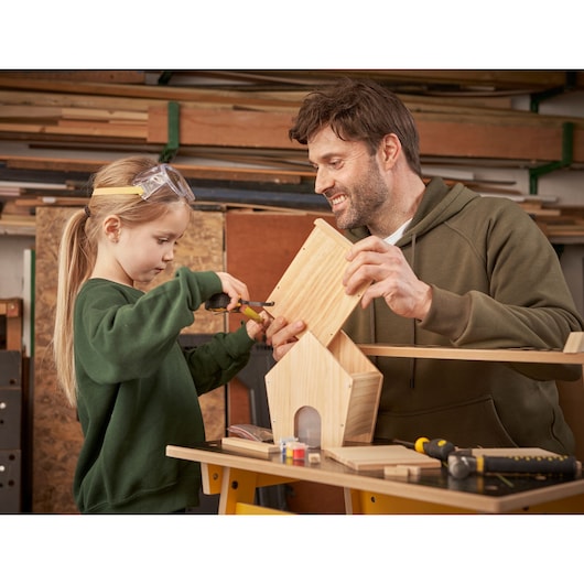 STANLEY K020-SY photography of woodworking, tools on table, person assembling wooden birdhouse in workshop.
