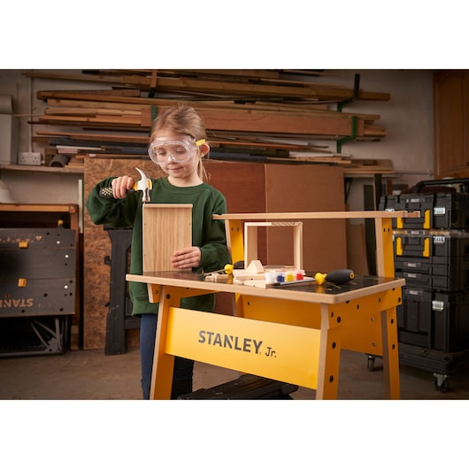 STANLEY K020-SY photography of a yellow STANLEY Jr. workbench with woodworking tools and a wooden project.