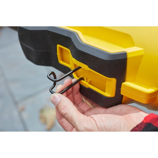 Stanley SFMCBL7M1 blower, yellow and black, side close-up showing metal hook attachment.