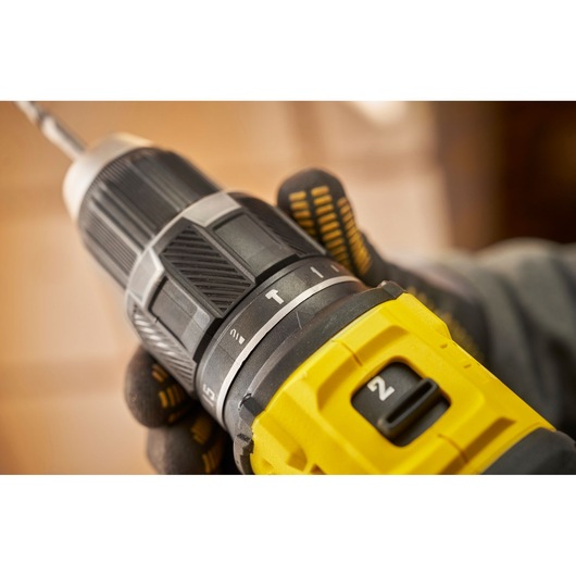 STANLEY SFMCD716B-XJ yellow and black cordless drill close-up, showing mode dial and speed selector.