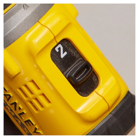 Stanley SFMCD720DR2 drill close-up on yellow casing and speed selector switch, front angle.