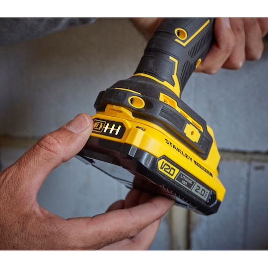 Photo of STANLEY SFMCD721DR2 cordless drill with V20 2.0Ah lithium-ion battery held in hand.