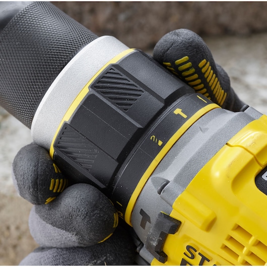 Photo of STANLEY SFMCD721DR2 drill body in close-up, showing textured black grip and yellow accents.