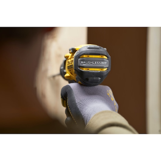STANLEY SFMCD725D2K brushless drill in use, close-up rear angle, yellow and black design.