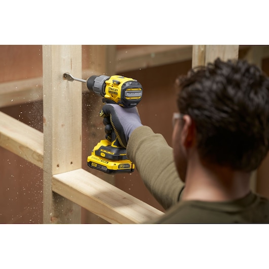 Photo of STANLEY SFMCD726D2K cordless drill being used to drill into wooden frame.