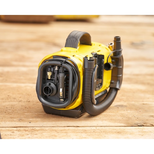 STANLEY SFMCE520B portable yellow vacuum with hose and attachments on wood surface, front angle.