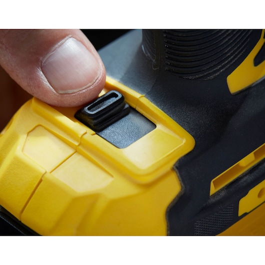STANLEY SFMCF820B drill close-up showing yellow and black mode switch pressed by a finger.