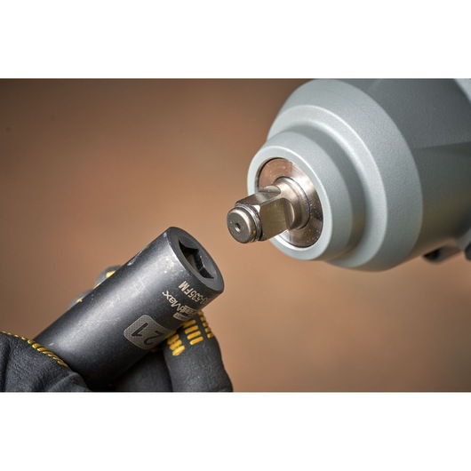 Photo of STANLEY SFMCF940B impact wrench close-up with socket attachment held by gloved hand.