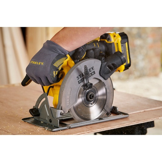 STANLEY SFMCS500B circular saw in use, yellow and gray design, cutting wood.
