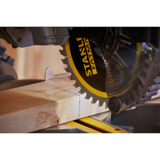 STANLEY SFMCS701B miter saw cutting wood, close-up photo of saw blade and timber.